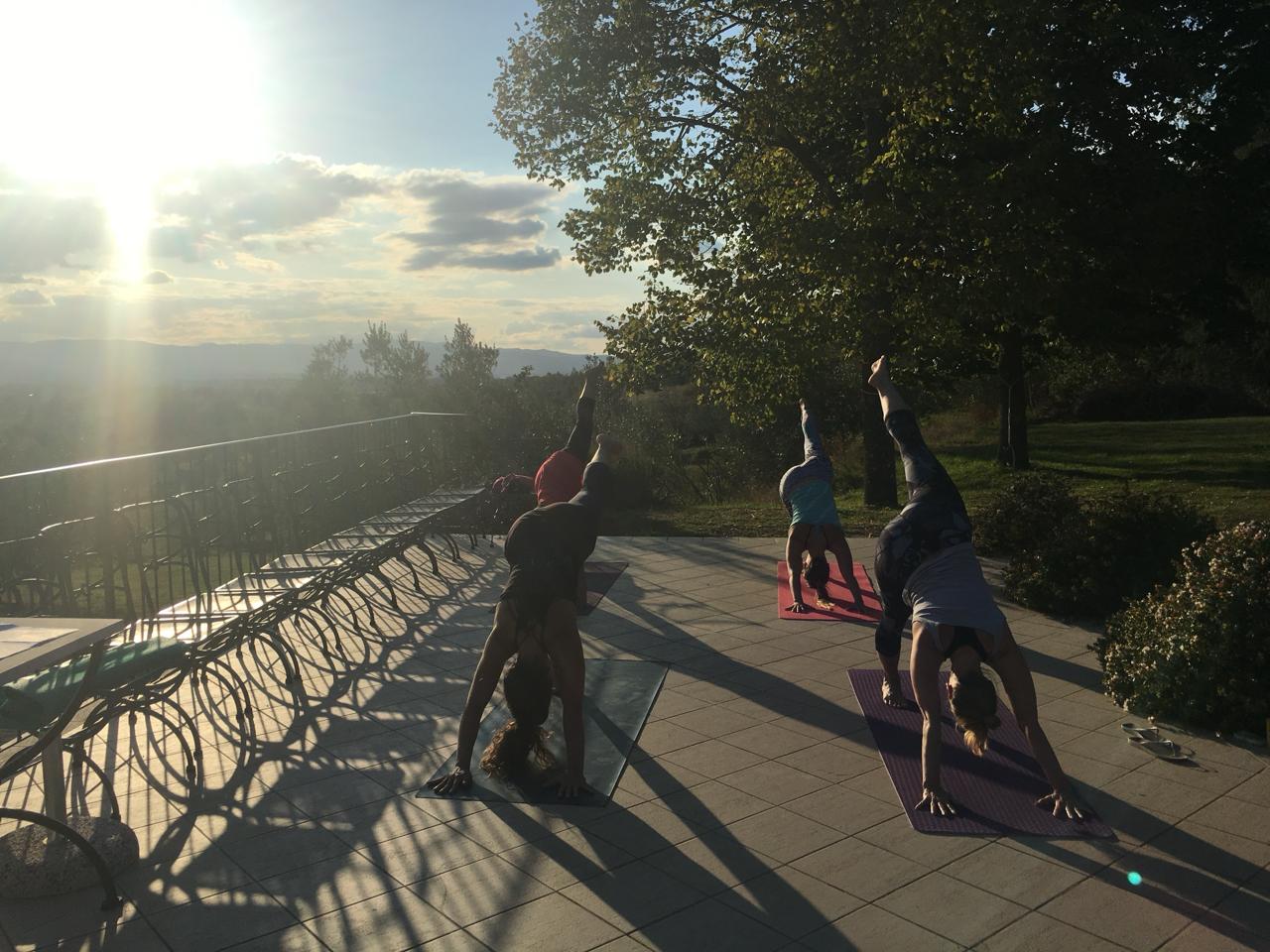 Sunset yoga silhouettes on the retreat terrace